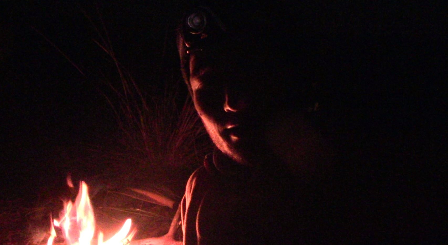 11d. Alfy by campfire in dark.JPG